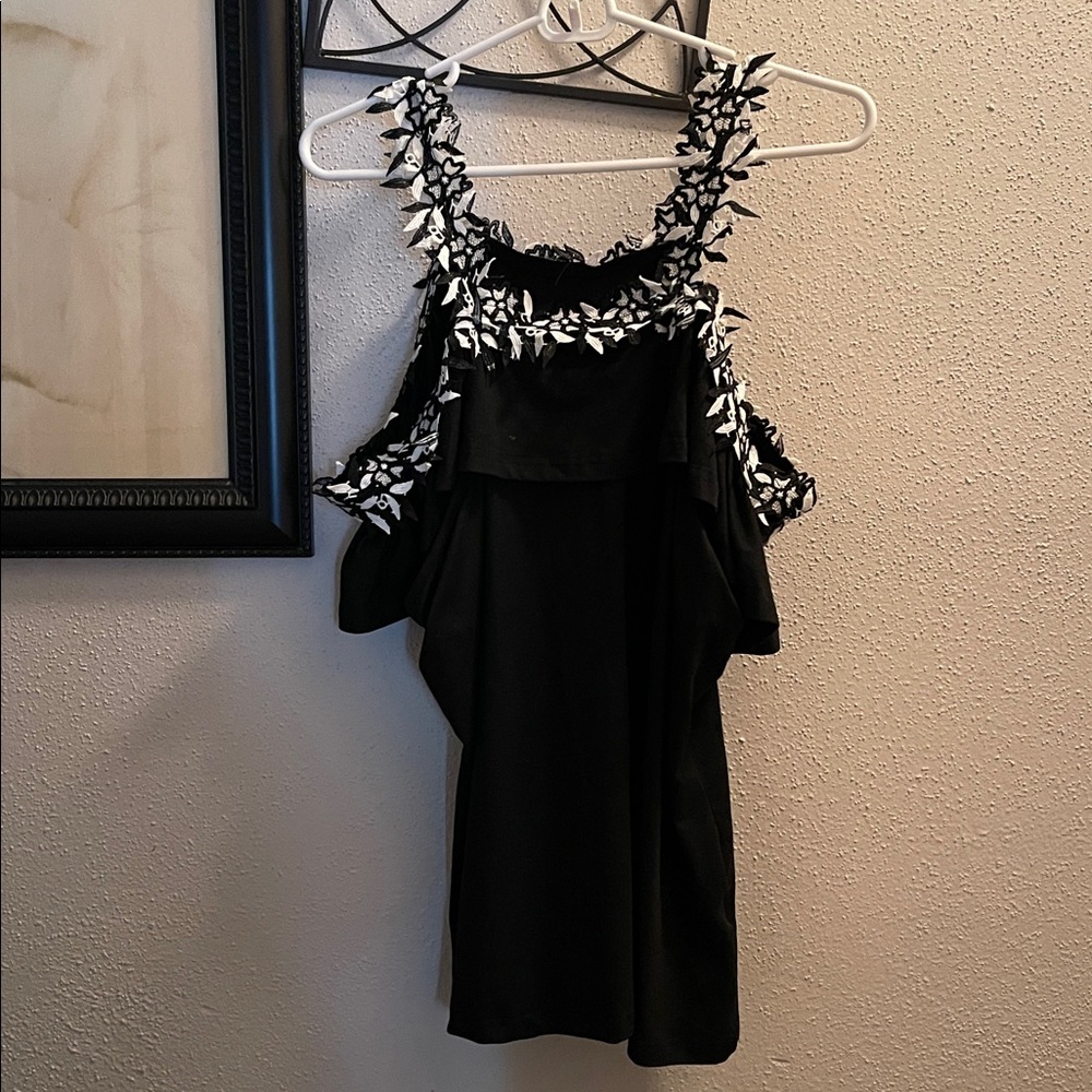 Black Sleeveless Top with White Floral Accents